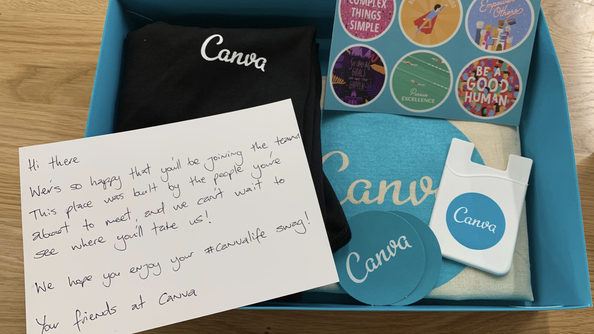 The box of swag and a personalized note that new hires receive in the mail after accepting the offer.