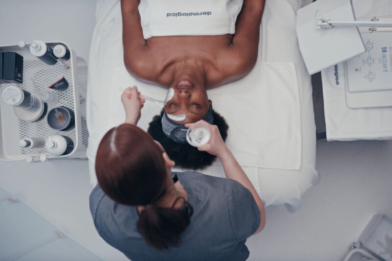 Header image for the Enboarder x Dermalogica Success Story featuring a Dermalogica therapist providing a facial treatment on a client