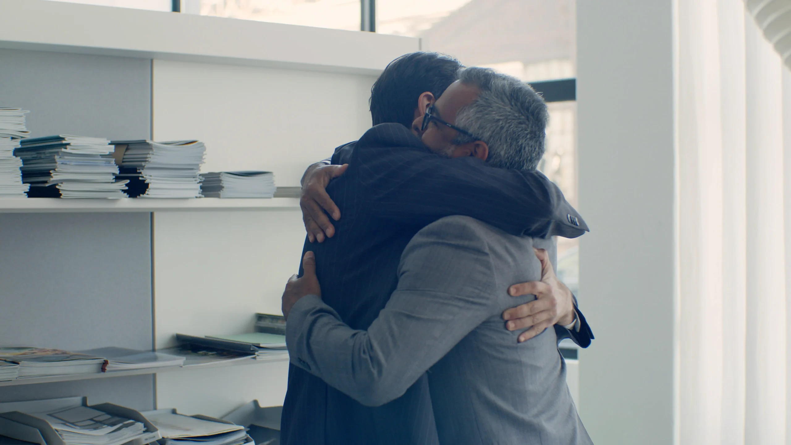 Two colleagues hugging during offboarding