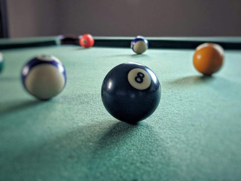 An 8 ball on a billiards table