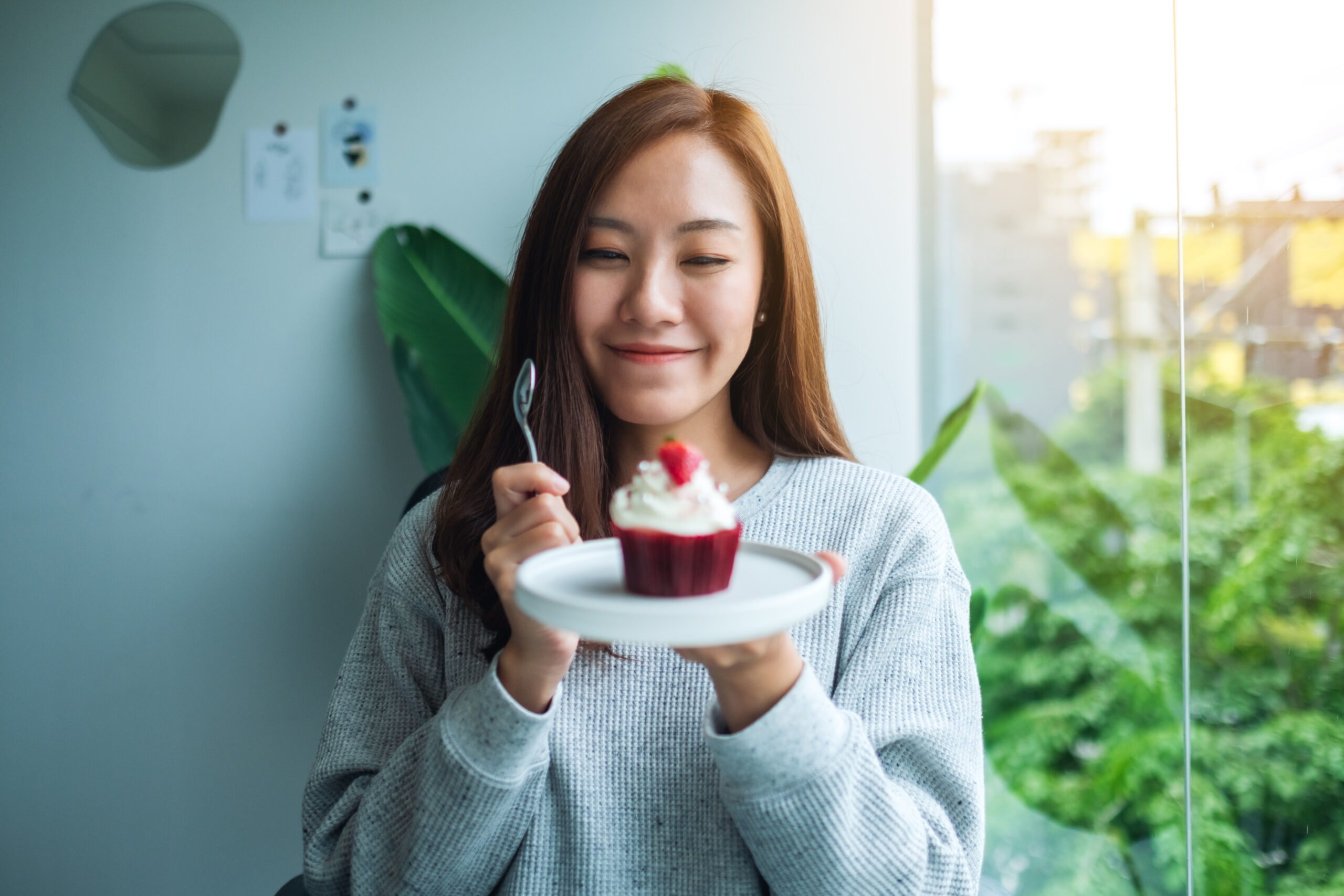woman holding a cupcake